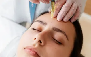 A woman receiving a profibirin injection on her face from skin care experts at a skincare clinic.