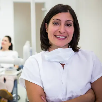 In a dentistry office, a woman demonstrates the ProFibrin Revolution with her arms crossed